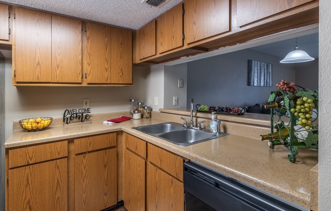A kitchen with wooden cabinets and a sink.