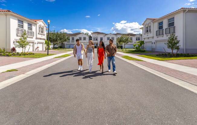 A group of people are walking down a street in a residential area.