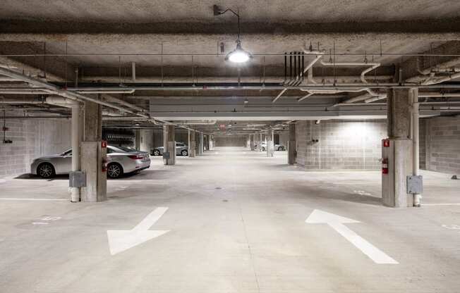 an empty parking garage with cars parked in it