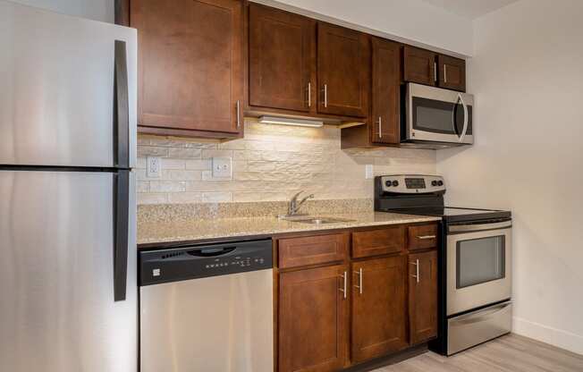 a kitchen with wooden cabinets and stainless steel appliances