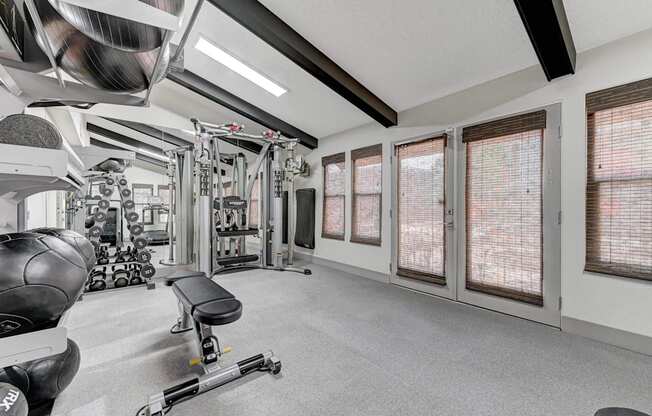 A well-equipped gym with a variety of machines and weights.
