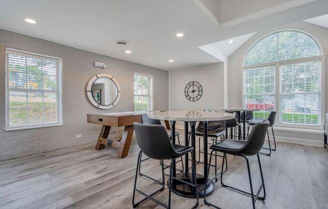 A dining room with a round table and chairs.