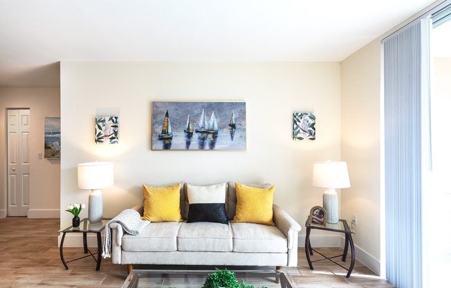 a living room with a couch and paintings on the wall