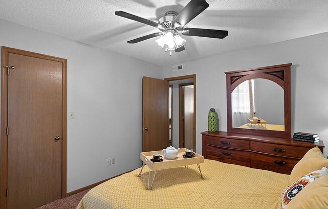 a bedroom with a bed and a ceiling fan