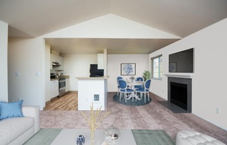 a living room and dining room with a table and chairs