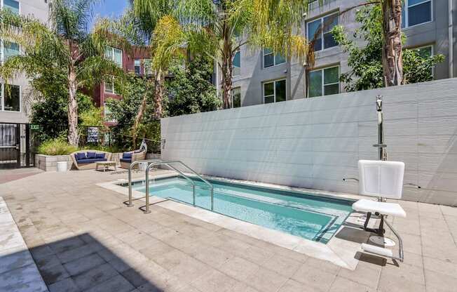 a swimming pool in the middle of a building with palm trees