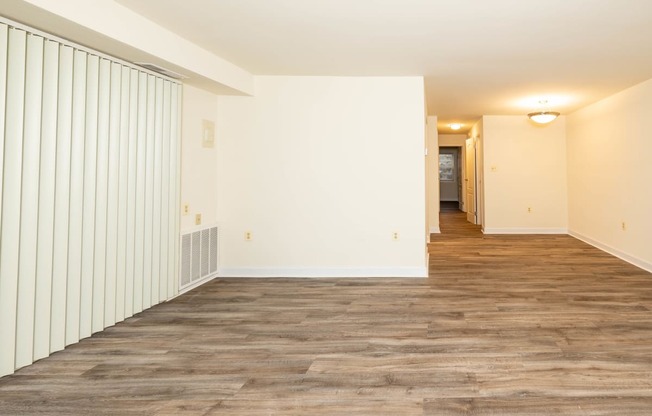 a living room with a wood floor and white walls