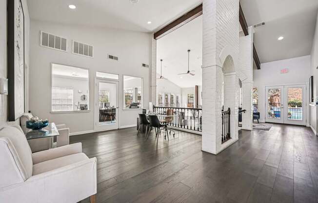 A white couch is in a room with a white column.