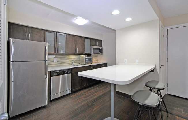 a kitchen with stainless steel appliances and a white counter top