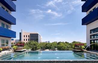 a swimming pool in the middle of two apartment buildings