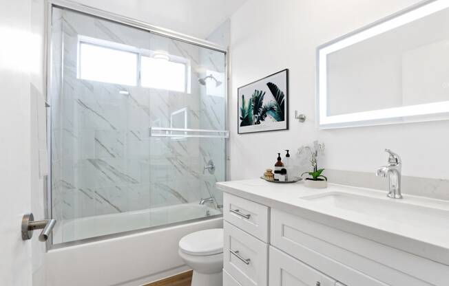 a bathroom with a shower and a sink and a toilet