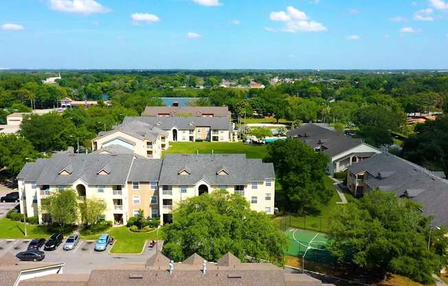 A large building with a green lawn in front.