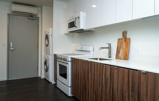 a kitchen with a washer and dryer and a sink