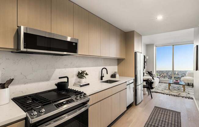 a kitchen with a stove and a sink and a refrigerator at The Paxton, New york