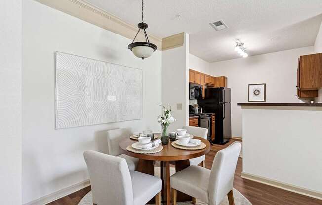 Open-concept dining area next to the kitchen at Tattersall Village Apartments near Richmond Hill, GA