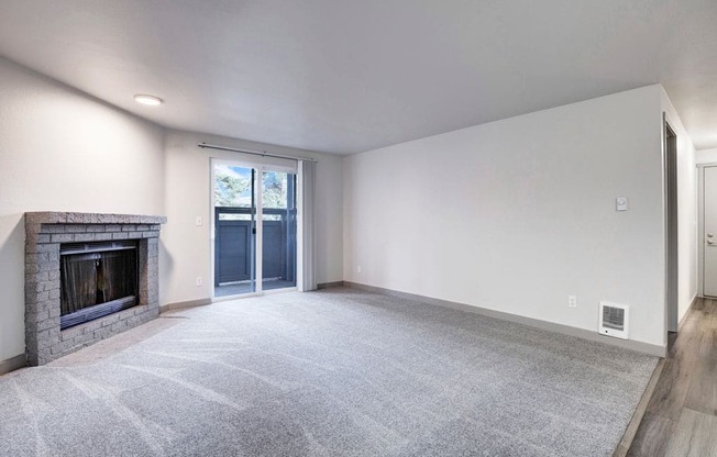 a living room with a fireplace and a door