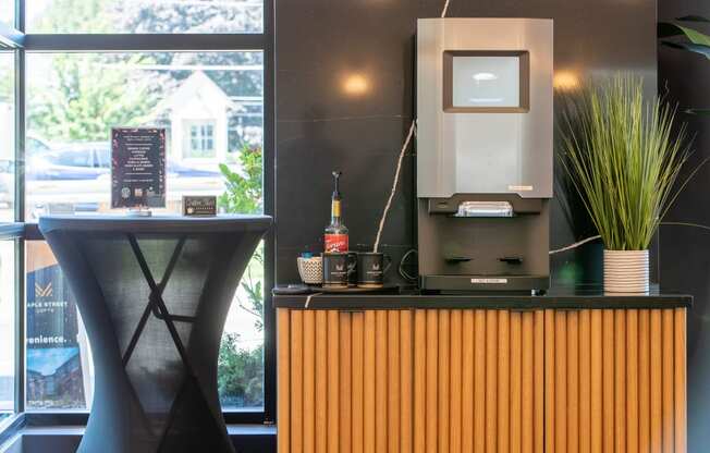 a desk with a computer on top of it next to a window