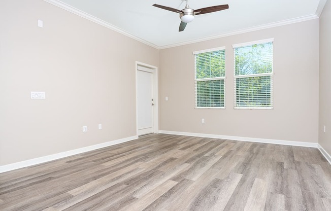 a bedroom with hardwood floors and a ceiling fan