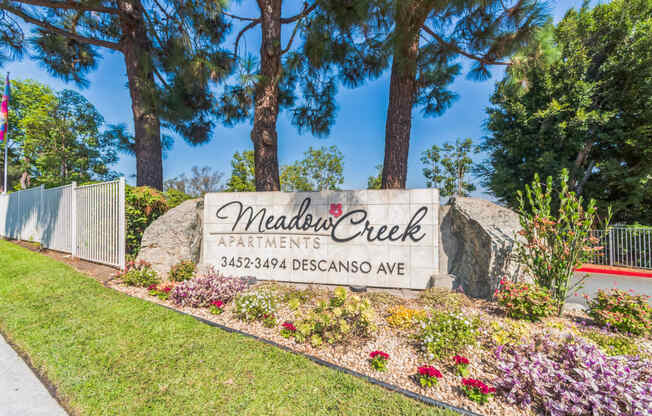 The Monument Sign at the property entrance of Meadow Creek Apartments in San Marcos, CA