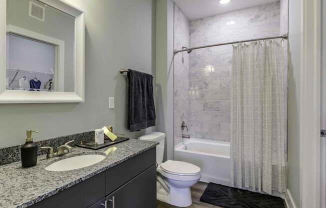a bathroom with a sink and a shower and a toilet at Echo Park at Perry Crossing Apartments, Plainfield, Indiana