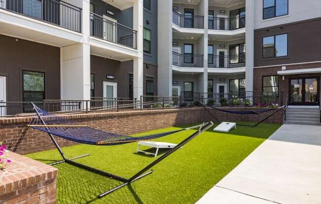 a rendering of a building with grass and benches