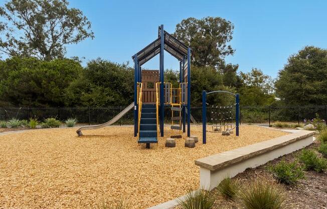 a playground with a swing set and a slide