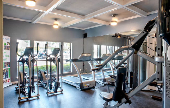 a gym with treadmills and other exercise equipment