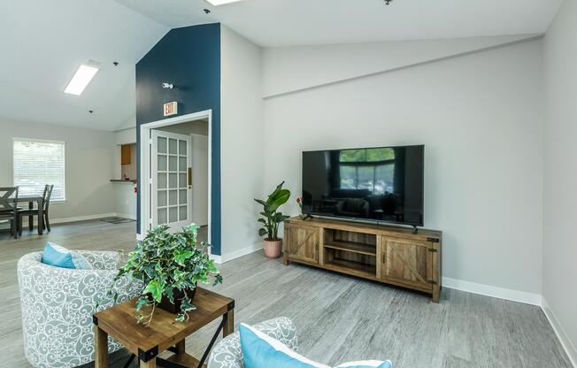 a living room filled with furniture and vase of flowers on a table