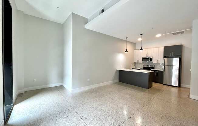 A kitchen area with a refrigerator, microwave, and oven.