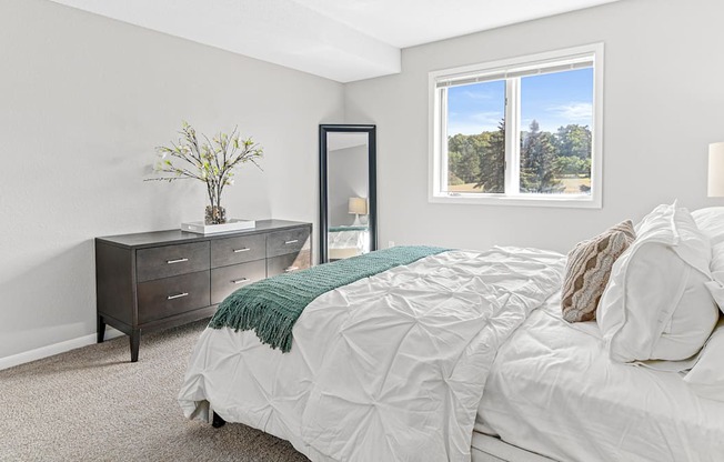 a bedroom with a bed and a window