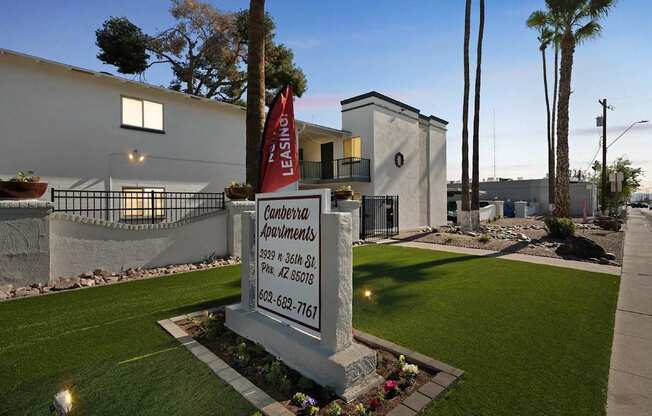 A sign for Leslie Apartments is displayed in front of a building.