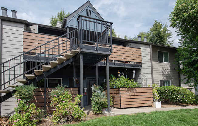 An apartment building with a balcony and stairs leading to the second floor at Pepperwood Apartments, California, 95661