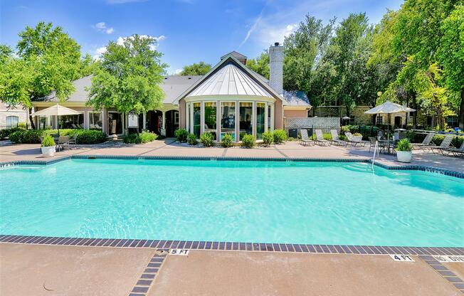 One of two pools with lush landscaping at Bentley Place at Willow Bend Apartments in West Plano, TX, For Rent. Now leasing 1, 2, and 3 bedroom apartments.