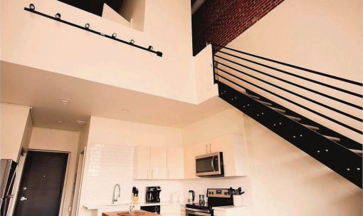a white kitchen with a microwave and a sink