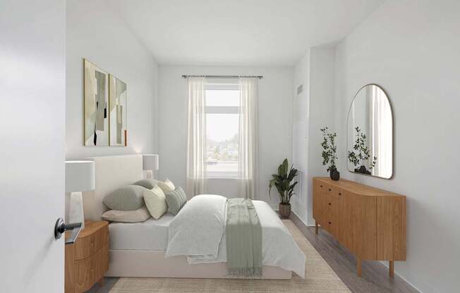 A bedroom with a bed, nightstand, and a plant.