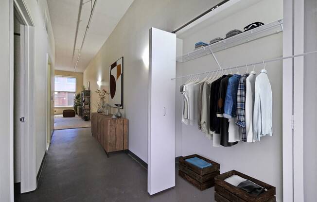 the walk in closet in the master bedroom is filled with closets and a wardrobe