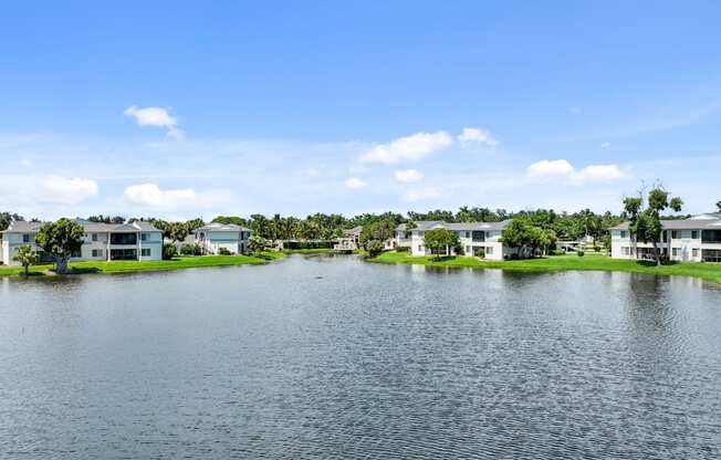 the view of a lake with houses on the side of it