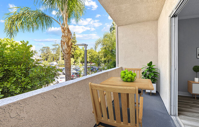 Large balcony with seating space and view of neighborhood of Chandler Circle Apartments.