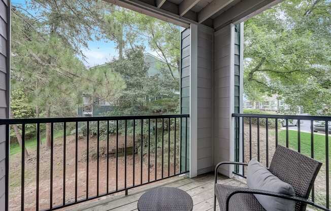a private balcony with a view of a yard and trees at Wynnwood Vinings Atlanta