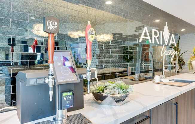 A modern bar with a black and white color scheme and a digital beer tap.