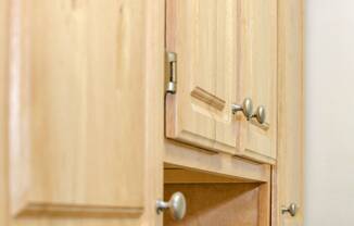 close of up oak wood kitchen cabinetry at fort totten apartments in washington dc