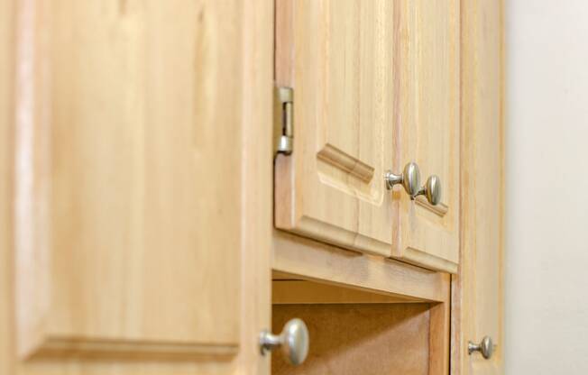 close of up oak wood kitchen cabinetry at fort totten apartments in washington dc