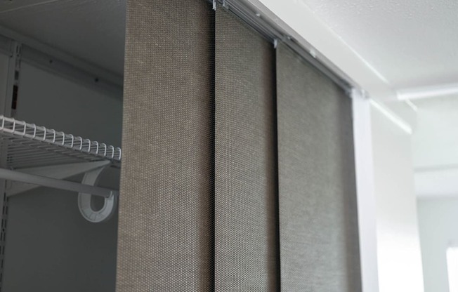 a shower curtain is hanging on the side of a closet at The Courts Midtown, Memphis, TN