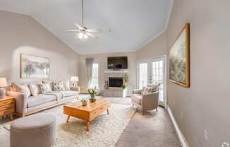 a living room with couches and chairs and a fireplace