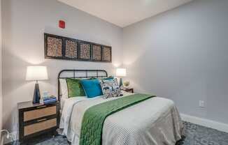 a bedroom with a bed and two lamps