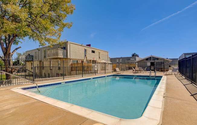 A large outdoor swimming pool surrounded by a fence.