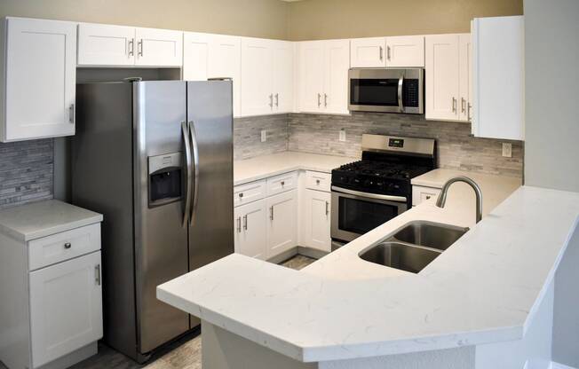 Kitchen with white cabinets and stainless appliances