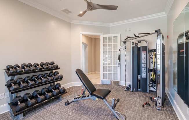 a home gym with weights and a yoga tower