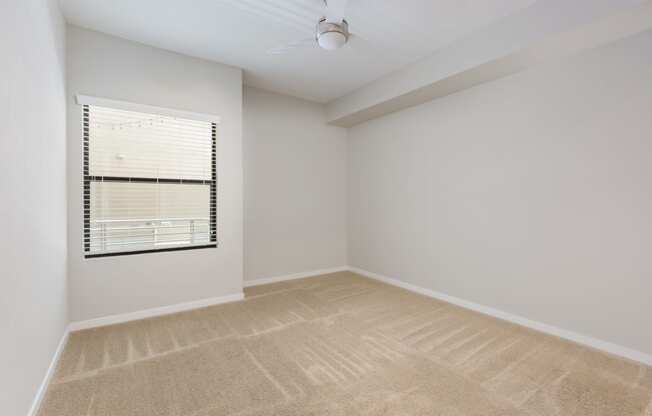 Carpeted Bedroom With Window At Union at Roosevelt Apartments In Phoenix, AZ