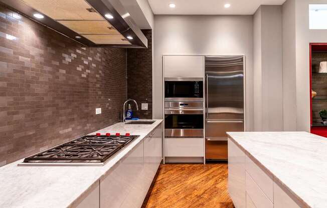 a kitchen with stainless steel appliances and white countertops